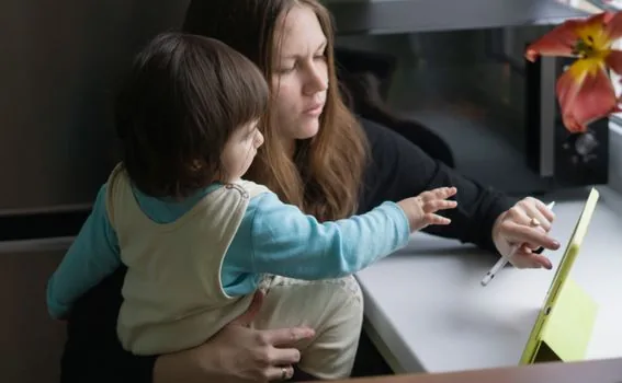 Korean parent filling infant developmental screening checklist beside toddler toys, tablet and paper notes, calm home evening light | 발달선별검사지 문항을 아이 행동과 대조해 작성하는 장면