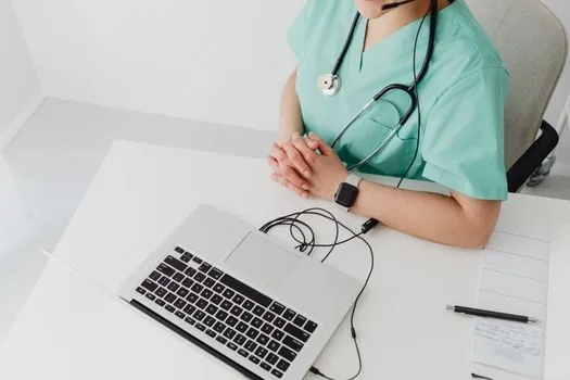 Korean patient comparing hospital receipt with online health insurance treatment history on laptop, bright desk and medical documents | 병원 영수증과 온라인 진료내역을 대조하는 장면