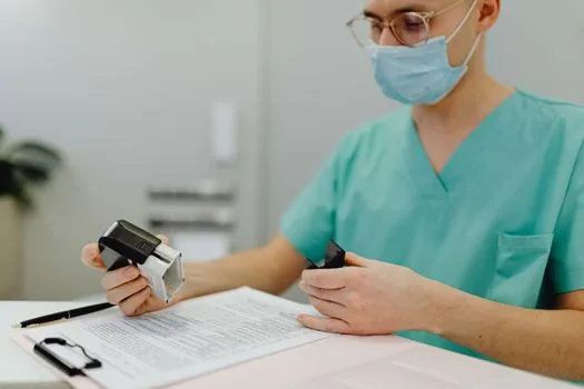 Korean patient organizing medical records, hospital receipts and USB medical imaging disc at bright desk, realistic editorial photo, no readable personal data | 진료기록과 영수증을 모아 신청 전 자료를 확인하는 장면