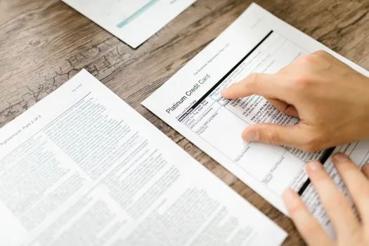 Korean person organizing medical receipt, detailed bill and pharmacy papers before checking fee review service, realistic bright table | 진료비 확인 신청 전 영수증과 세부산정내역서를 정리하는 장면