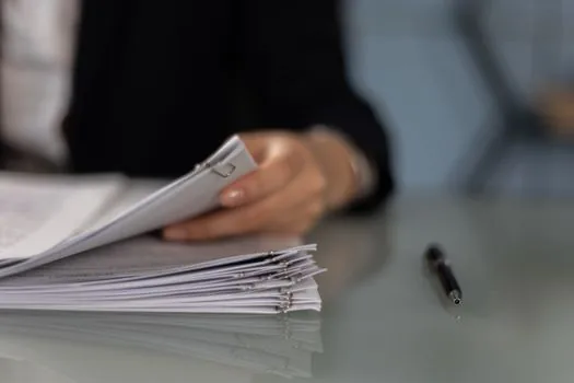 Korean real estate paperwork desk with land lot number, building register, registry copy and pencil checklist, realistic bright administrative photo, no readable private data | 토지대장 주소 오류를 지번 기준으로 대조하는 장면
