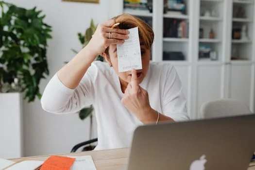 person comparing insurance claim checklist and hospital certificate fee receipt