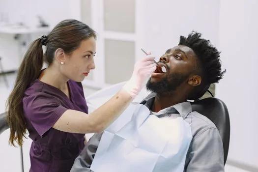 person making dental appointment while checking national health insurance scaling eligibility on phone | 치과 예약 전 스케일링 보험 대상 여부를 확인하는 장면