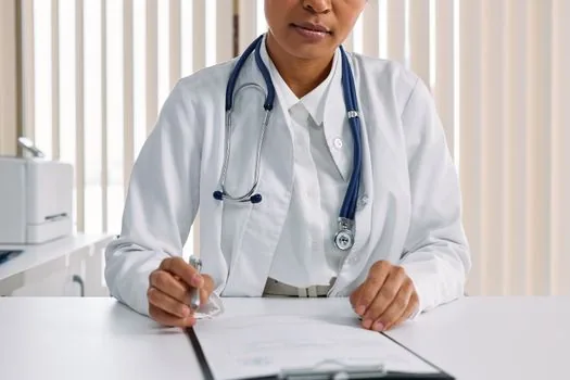 Public health center consultation desk with fertility treatment support application checklist and pen, Korean administrative health service scene | 보건소 상담 창구에서 신청 경로와 서류를 확인하는 장면