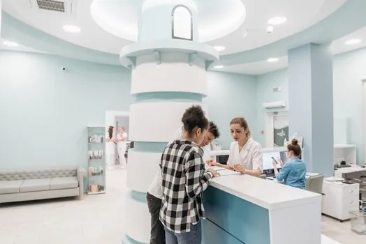 worker compensation claim form documents on desk beside clinic reception, realistic Korean public service article support photo, no brand logos