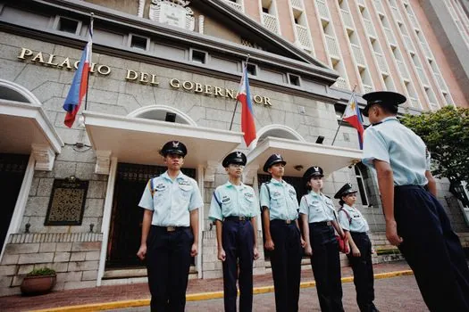Korean local government officials rehearsing synchronized dance outside city hall for a regional ginseng festival campaign, black work uniforms, vice mayor with white shirt and tie, realistic editorial photo, no readable text